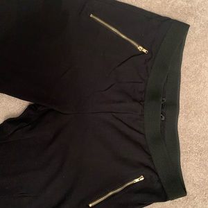 Black stretchy ankle pants w/ gold zipper pockets